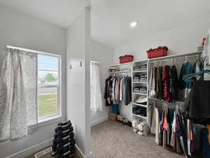 Walk in closet with light carpet