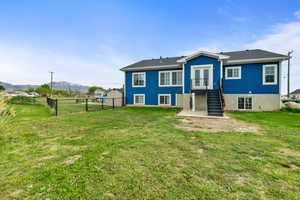 Rear view of house featuring a mountain view and stairway