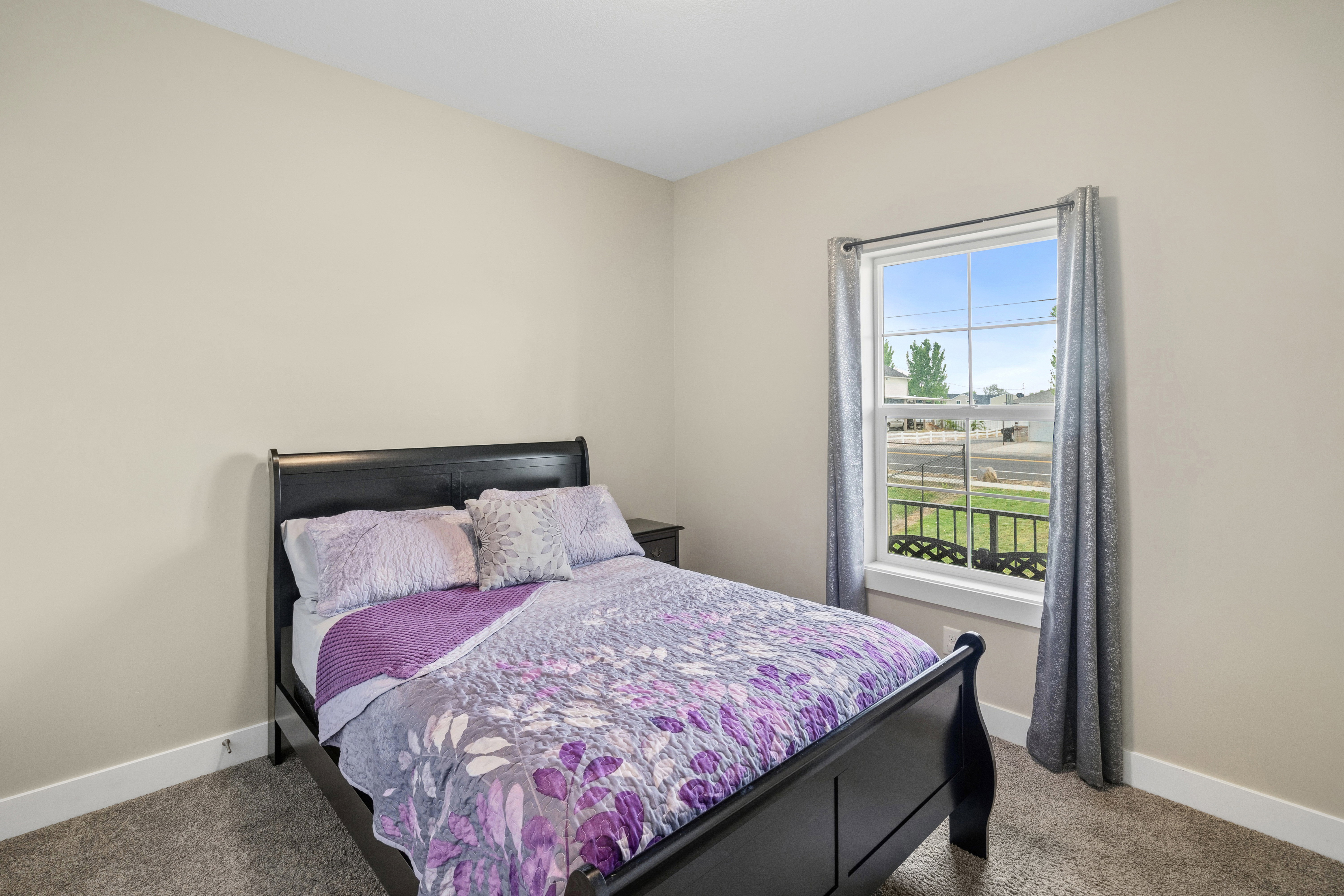 Carpeted bedroom featuring baseboards