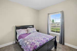 Carpeted bedroom featuring baseboards