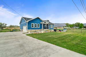 View of front of property featuring driveway, board and batten siding, a mountain view, and an attached garage