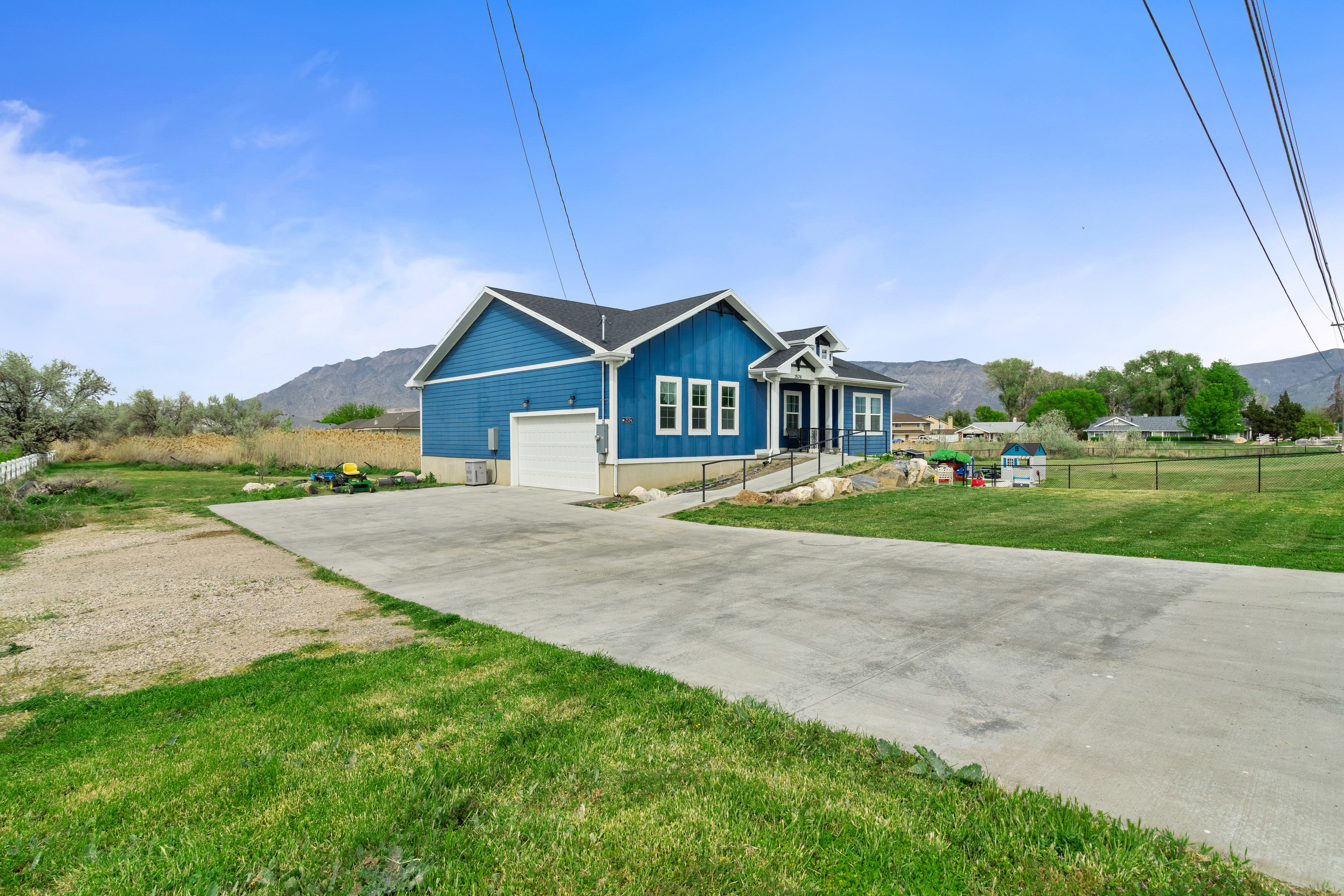 View of front of house with a mountain view, concrete driveway, board and batten siding, and a garage