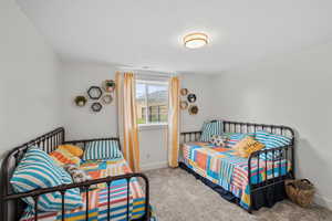 Bedroom with light carpet and a mountain view