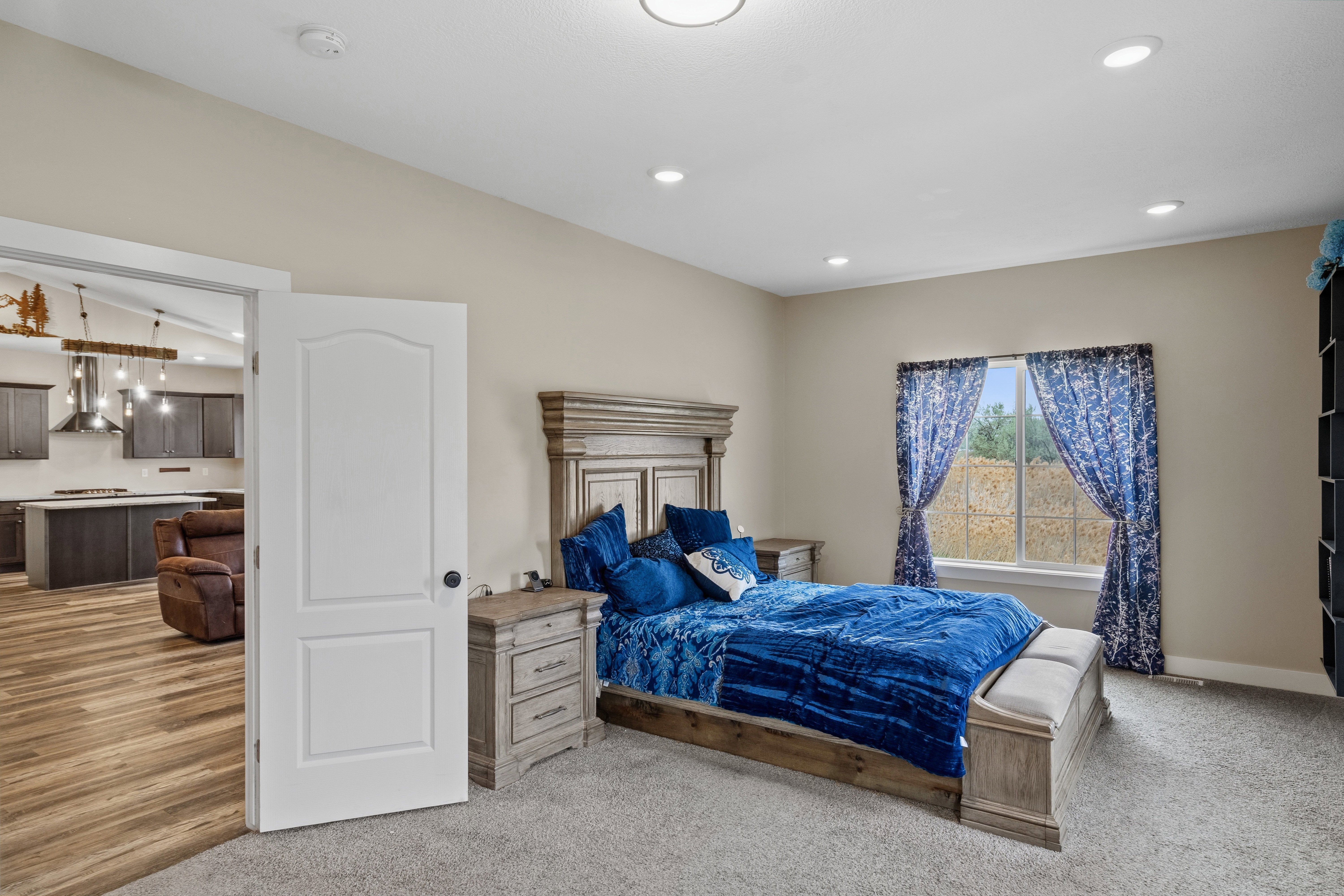 Bedroom featuring light carpet, vaulted ceiling, and recessed lighting