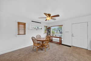 Dining area featuring ceiling fan and carpet flooring