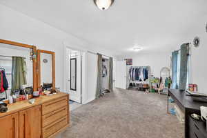 Bedroom featuring light colored carpet