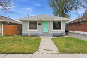 Bungalow-style home with brick siding and roof with shingles