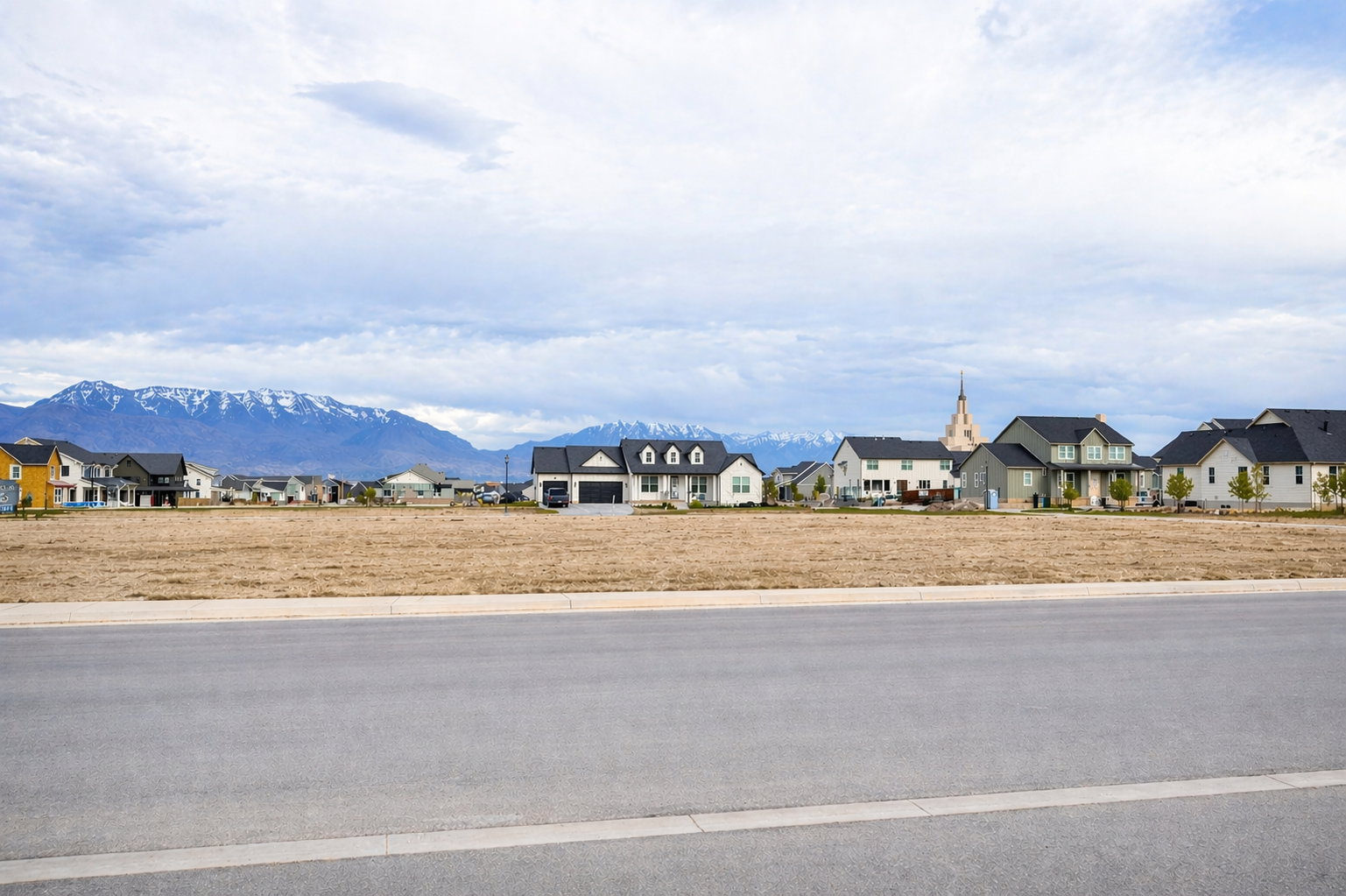 View of asphalt street with curbs, a residential view, and a mountain view