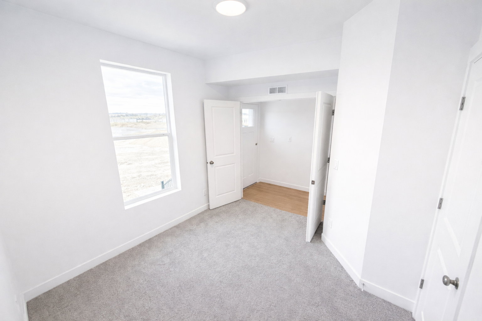 Unfurnished bedroom featuring baseboards and light colored carpet
