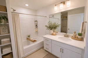 Full bathroom with vanity and shower / bath combination with curtain