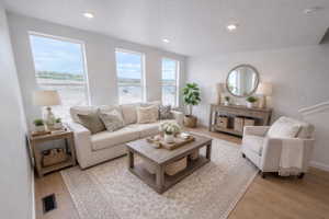 Living area featuring light wood-style flooring and recessed lighting