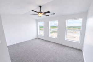 Carpeted empty room with baseboards and ceiling fan