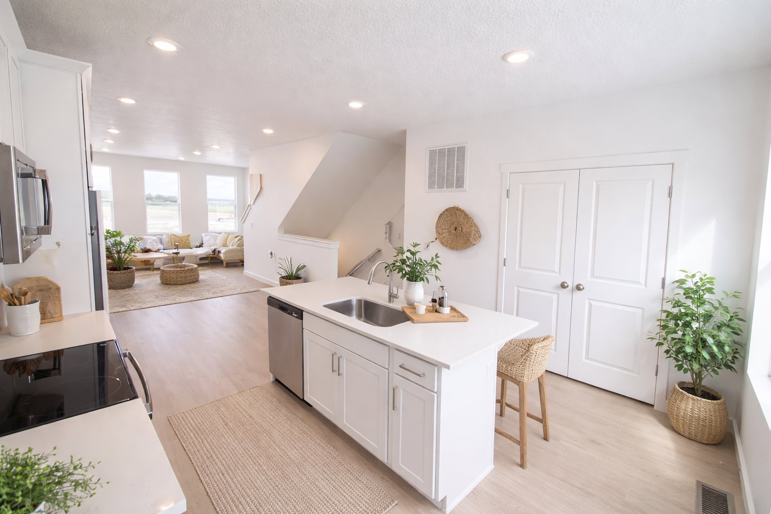 Kitchen featuring an island with sink, white cabinetry, light wood-type flooring, open floor plan, and recessed lighting
