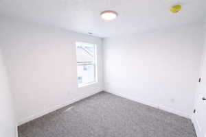 Spare room with carpet flooring and a smoke detector