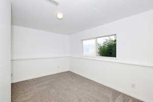 Carpeted spare room with baseboards and a textured ceiling