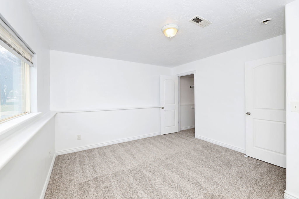 Unfurnished bedroom with carpet flooring and a textured ceiling