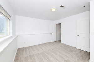 Unfurnished bedroom with carpet flooring and a textured ceiling