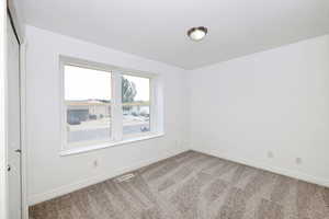 Empty room with carpet flooring and baseboards