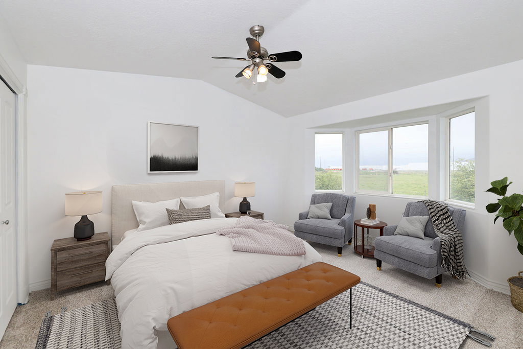 Bedroom with carpet, a ceiling fan, and lofted ceiling