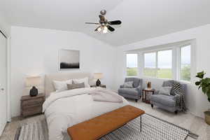 Bedroom with carpet, a ceiling fan, and lofted ceiling