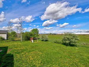 View of yard with a view of countryside and a playground
