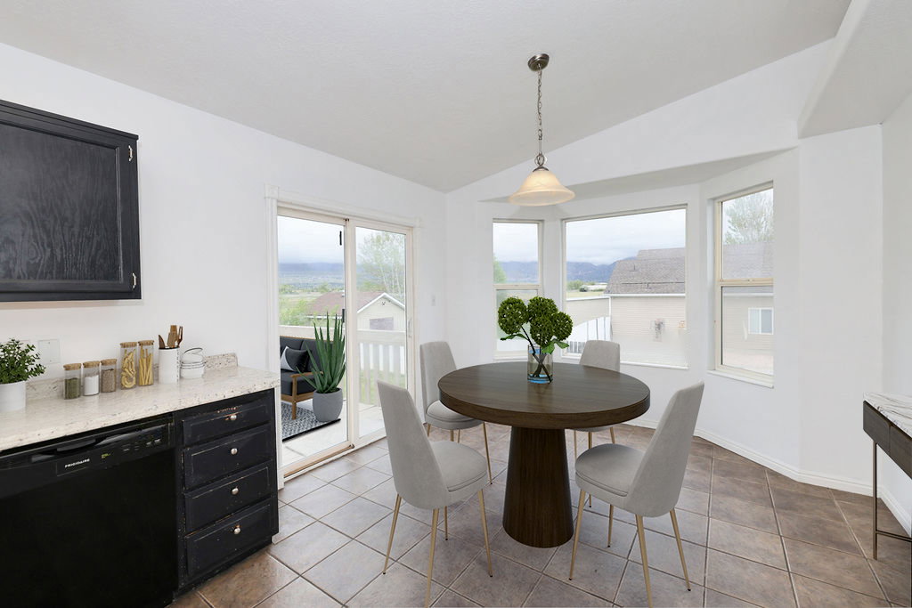 Dining space featuring vaulted ceiling and baseboards