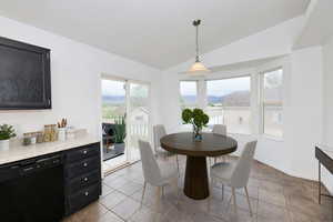 Dining space featuring vaulted ceiling and baseboards