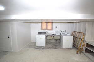 Laundry area featuring unfinished concrete floors and independent washer and dryer