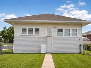 Back of house with a shingled roof