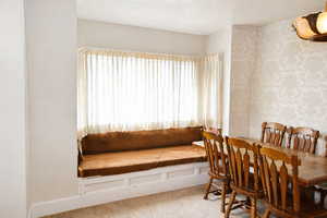 Dining room featuring light colored carpet