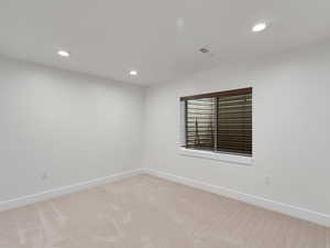 Empty room with recessed lighting and carpet floors