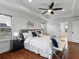 Bedroom with dark wood finished floors, a ceiling fan, recessed lighting, and a tray ceiling