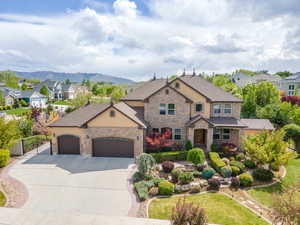 View of front of home featuring an attached garage, a residential view, stucco siding, and driveway