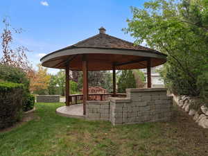 View of green lawn with a gazebo and a patio area