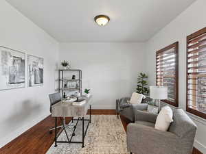 Office space with dark wood-style flooring and baseboards