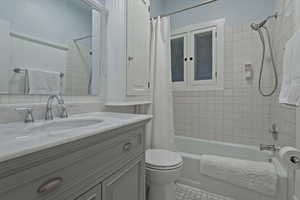 Bathroom featuring vanity and shower / tub combo with curtain