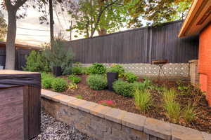 Fenced backyard with a hot tub