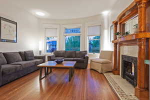 Living area featuring wood-type flooring and a fireplace