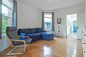 Living room with light wood-style flooring and baseboards