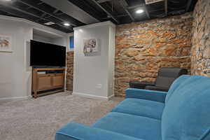 Carpeted living room featuring baseboards