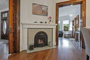 Living area with a tile fireplace and dark wood finished floors