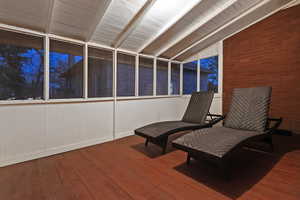 Sitting room featuring lofted ceiling with beams and wood-type flooring