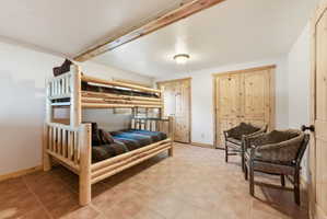 Bedroom with a closet and light tile patterned floors