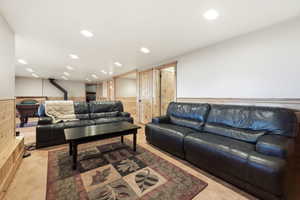 Living area featuring a wainscoted wall, recessed lighting, wooden walls, and light tile patterned floors