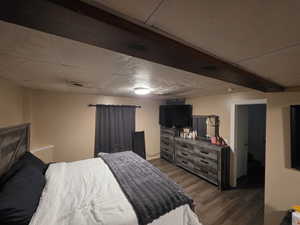 Bedroom featuring dark wood-style flooring
