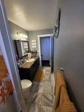 Bathroom with vanity and a textured ceiling
