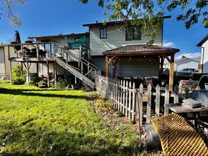 Back of house with a deck and a gazebo