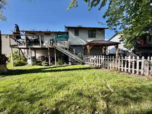 Back of property with a deck and a gazebo