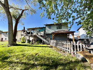 Rear view of property with a deck and a gazebo