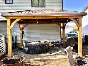 View of patio with a gazebo, a fire pit, and area for grilling